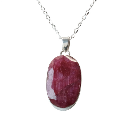 Ruby oval pendant necklace in sterling silver, promoting joy and confidence with its vibrant energy.