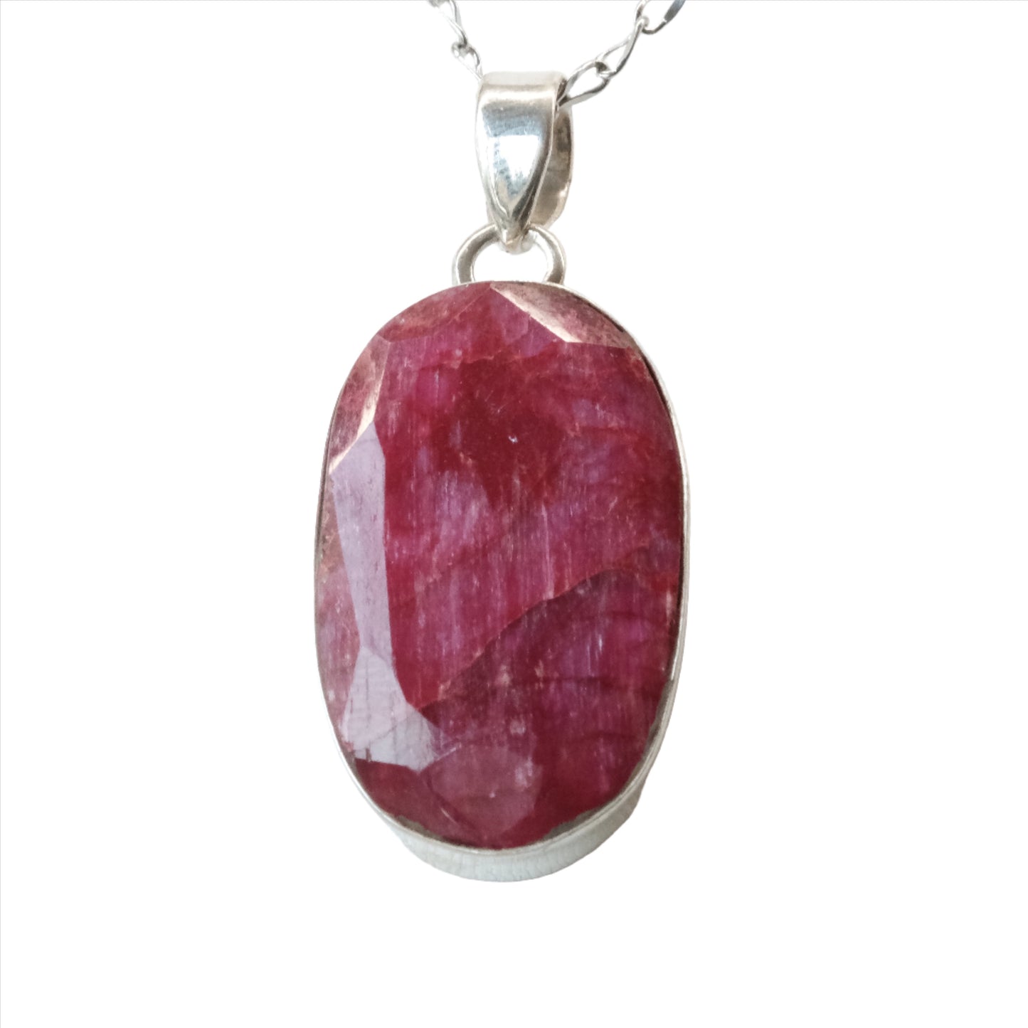 Ruby oval pendant necklace in sterling silver, showcasing a vibrant gemstone that promotes confidence and vitality.