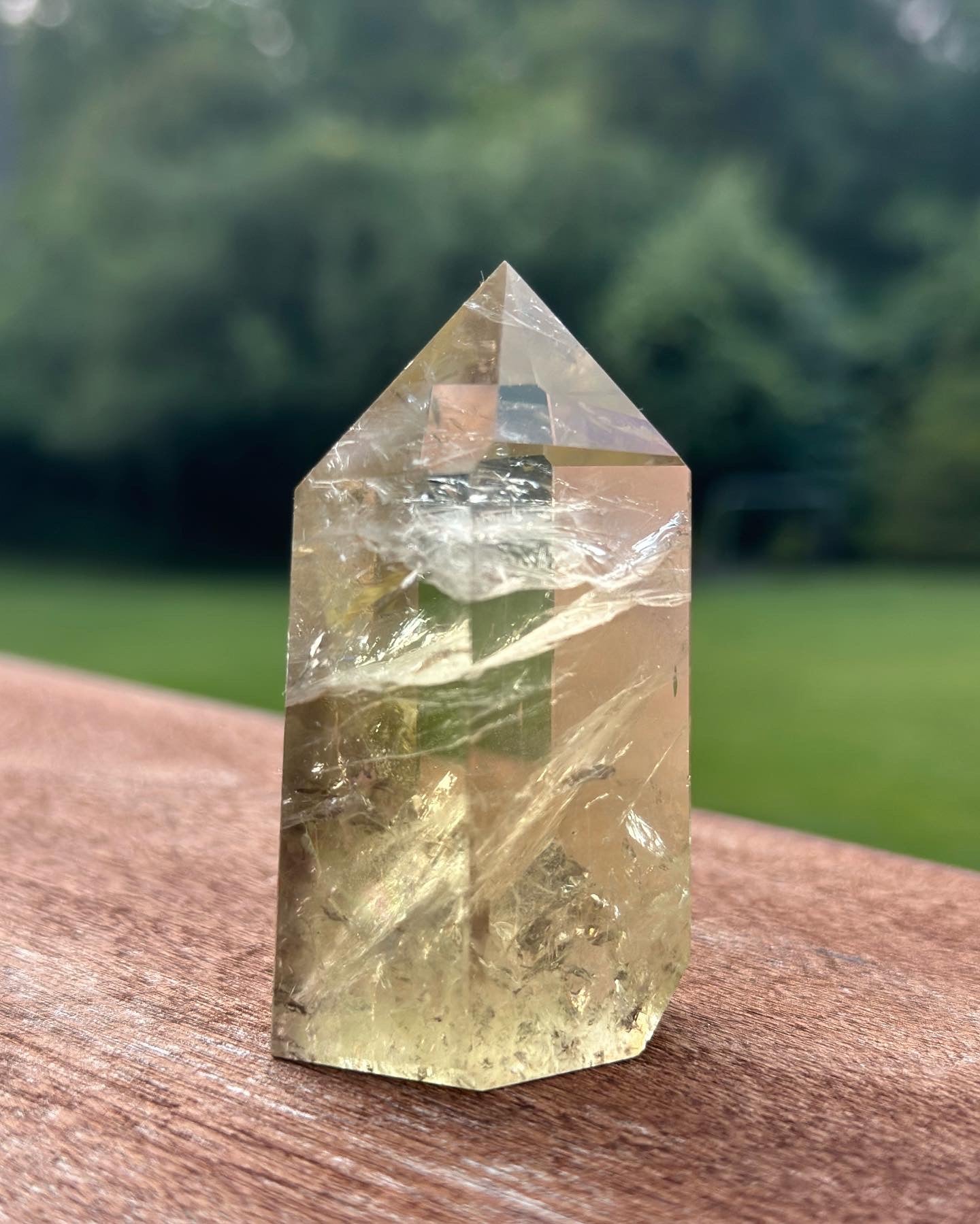 Citrine Tower crystal showcasing its vibrant yellow color and natural facets, symbolizing energy and prosperity.