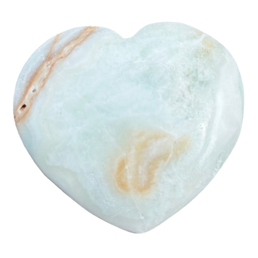 Caribbean calcite heart stone promoting serenity and personal growth with natural colors and smooth surface.