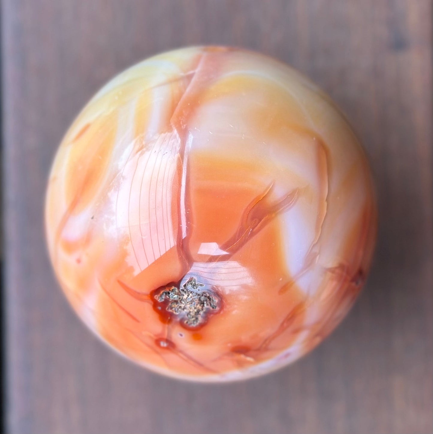 Carnelian sphere 1017g, 3.5 inches in diameter, showcasing vibrant reddish-orange hues and unique patterns.