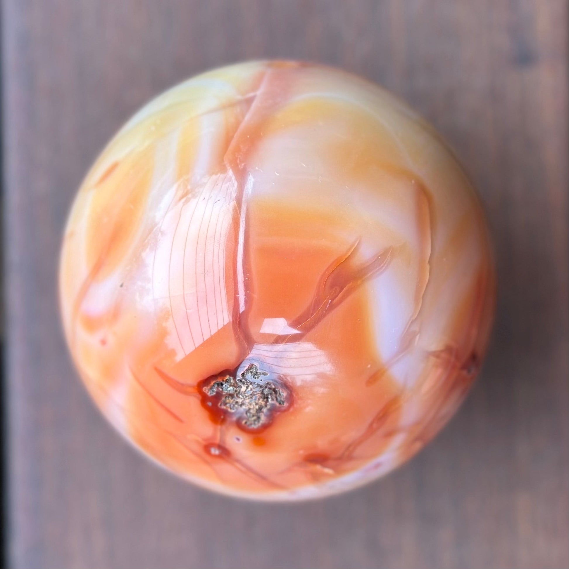 Carnelian sphere 1017g, 3.5 inches in diameter, showcasing vibrant reddish-orange hues and unique patterns.