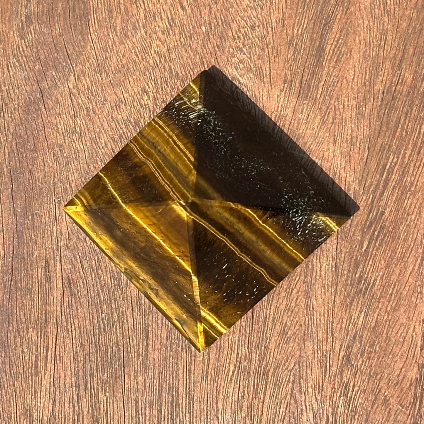 Tiger Eye Pyramid for focus, protection, and mood stabilization; enhances willpower and treats physical ailments.