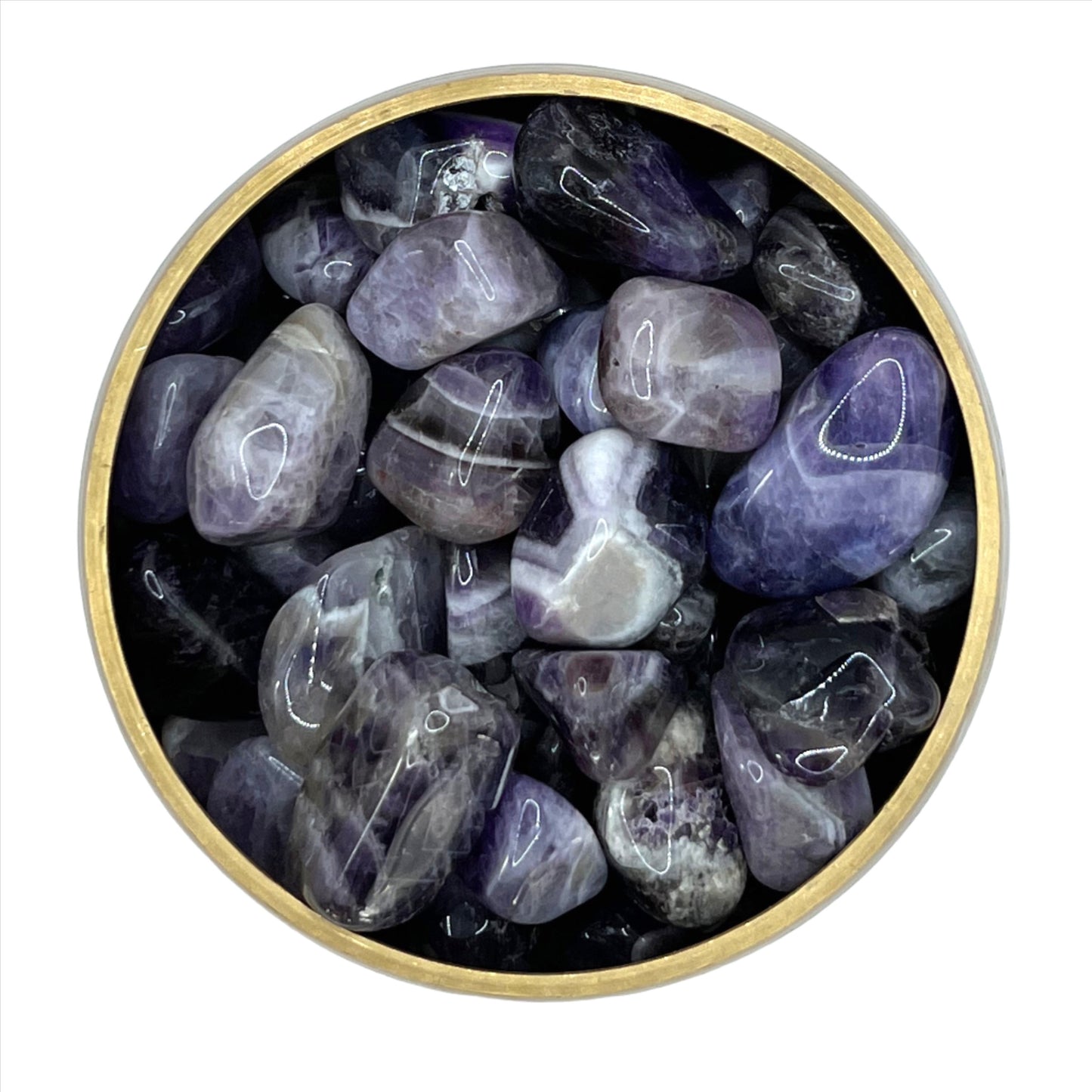 Chevron Amethyst tumbled stones in a bowl, known for reducing anxiety and stress with calming energy.
