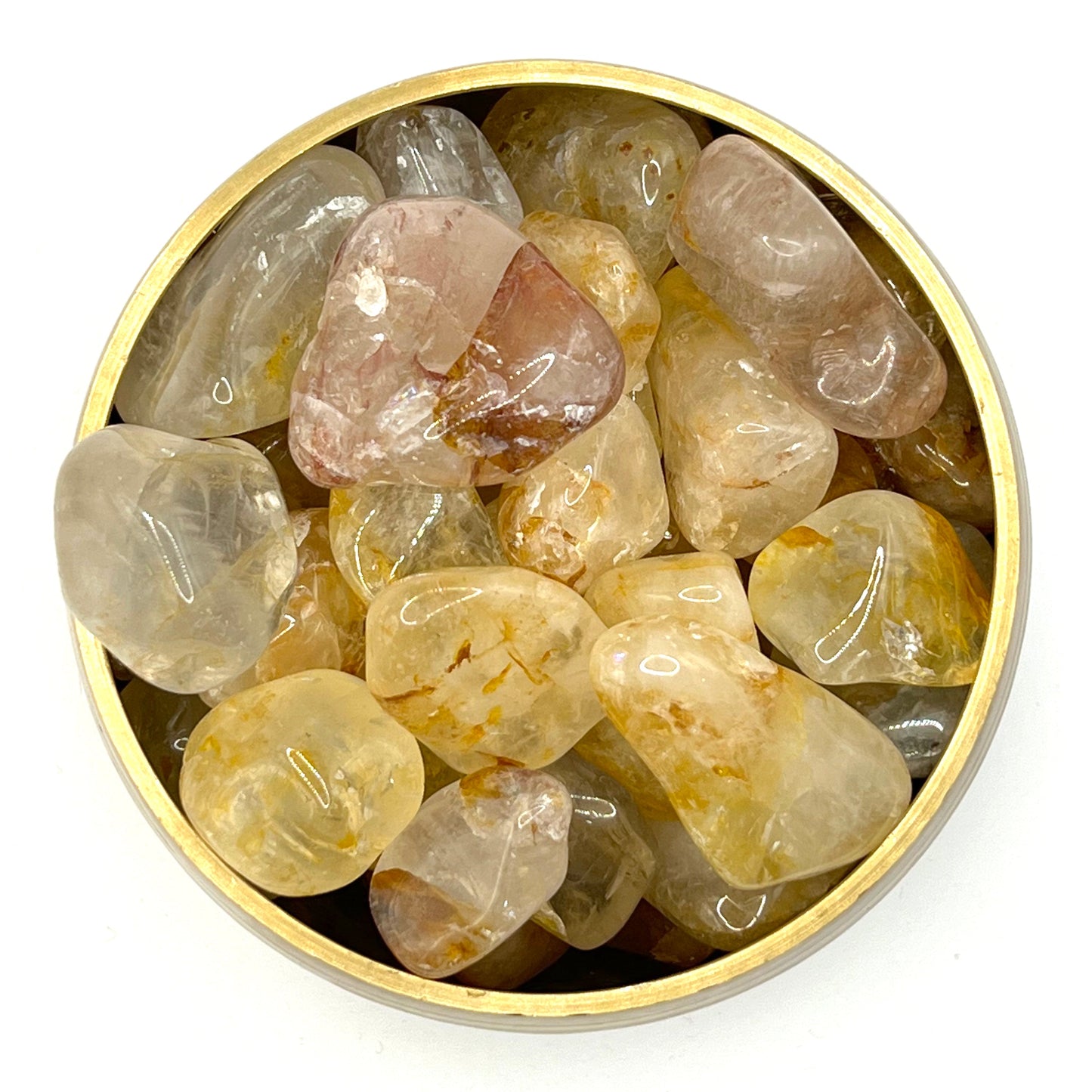 Golden Healer Tumbled Stones in a round container for spiritual healing and balance.