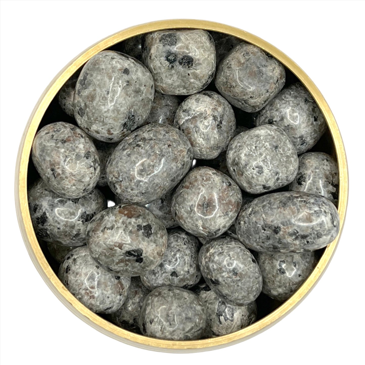 Larvakite tumbled stones in a round container, dark-grey with black specks, used for healing and relaxation.