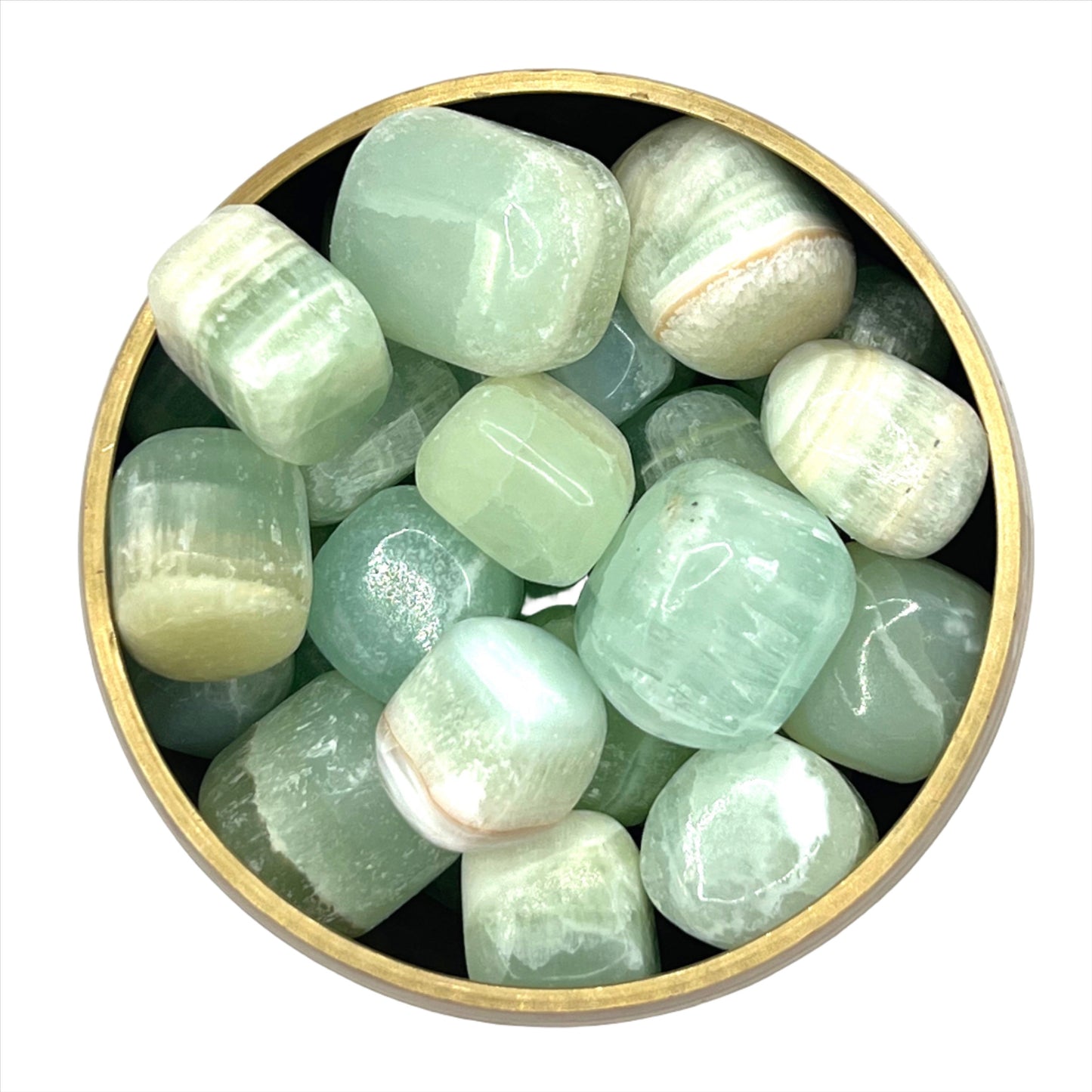 Tumbled green calcite stones in a brass bowl for mental balance and emotional healing.