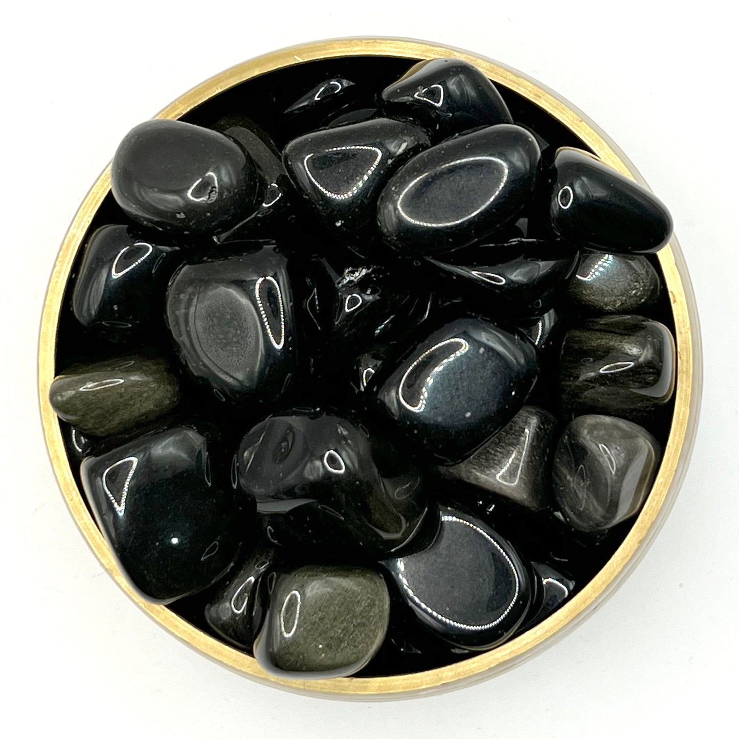 Tumbled golden sheen obsidian stones in a round gold bowl, showcasing their glass-like surface and shimmering effect.