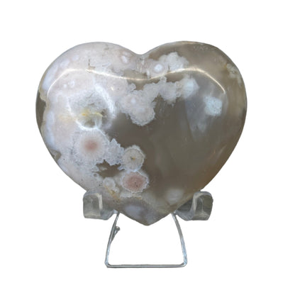 Flower Agate Heart with pink hues and delicate inclusions, weighing 238g, shown on a stand against a white background.