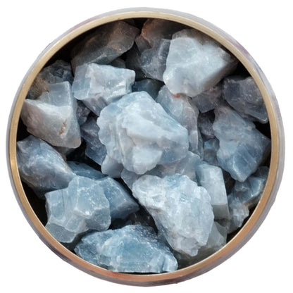 Raw blue calcite stones in a round bowl, ideal for healing and promoting clear communication.