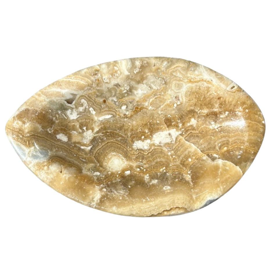 Elegant calcite bowl with natural earthy tones and unique marbling, perfect for decor or serving.