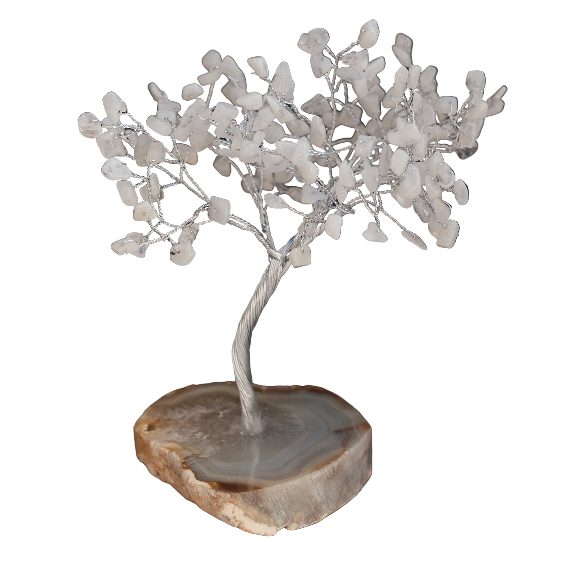 Decorative tree sculpture on a wooden base against a black background