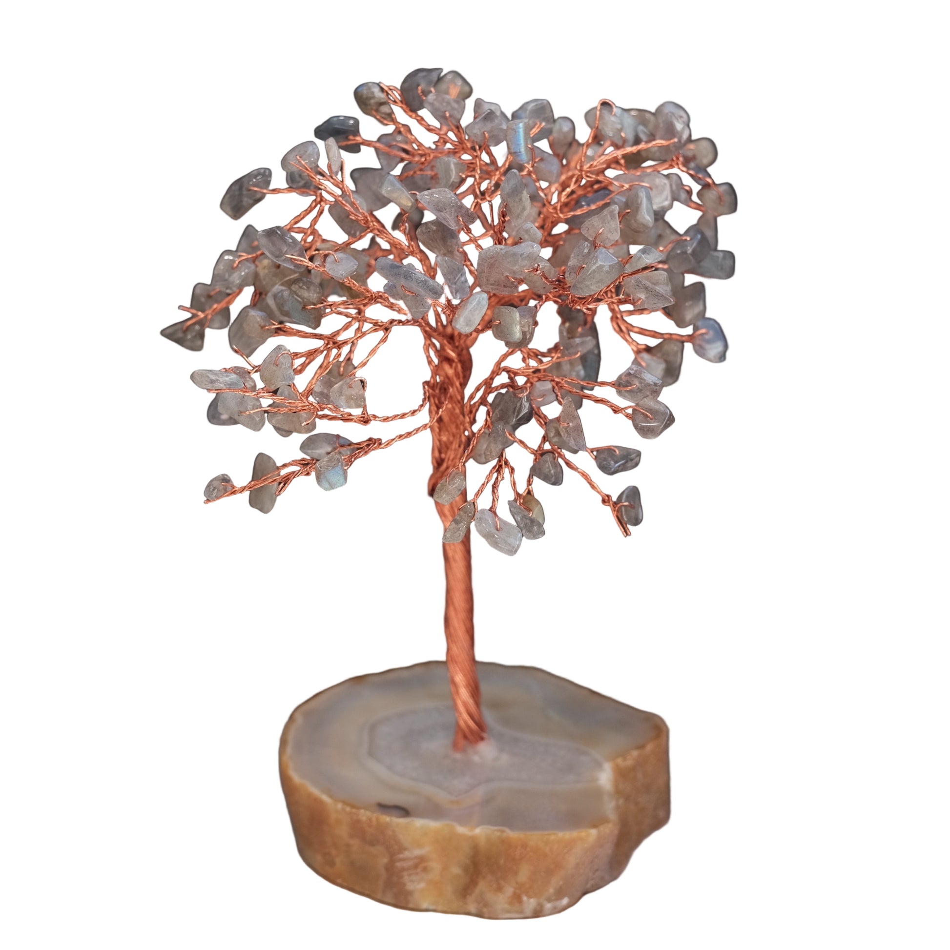 Decorative tree sculpture with stones on a dark background