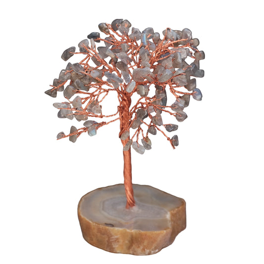Decorative tree sculpture with stones on a dark background