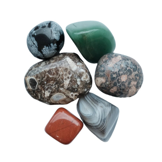 Assorted cleansed and charged gemstones for the Develop Perseverance Kit, enhancing tranquility and joy through daily rituals.