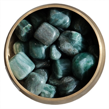 Emerald with Fuchsite tumble stones showcasing vibrant green hues, known for promoting love, loyalty, and emotional healing.