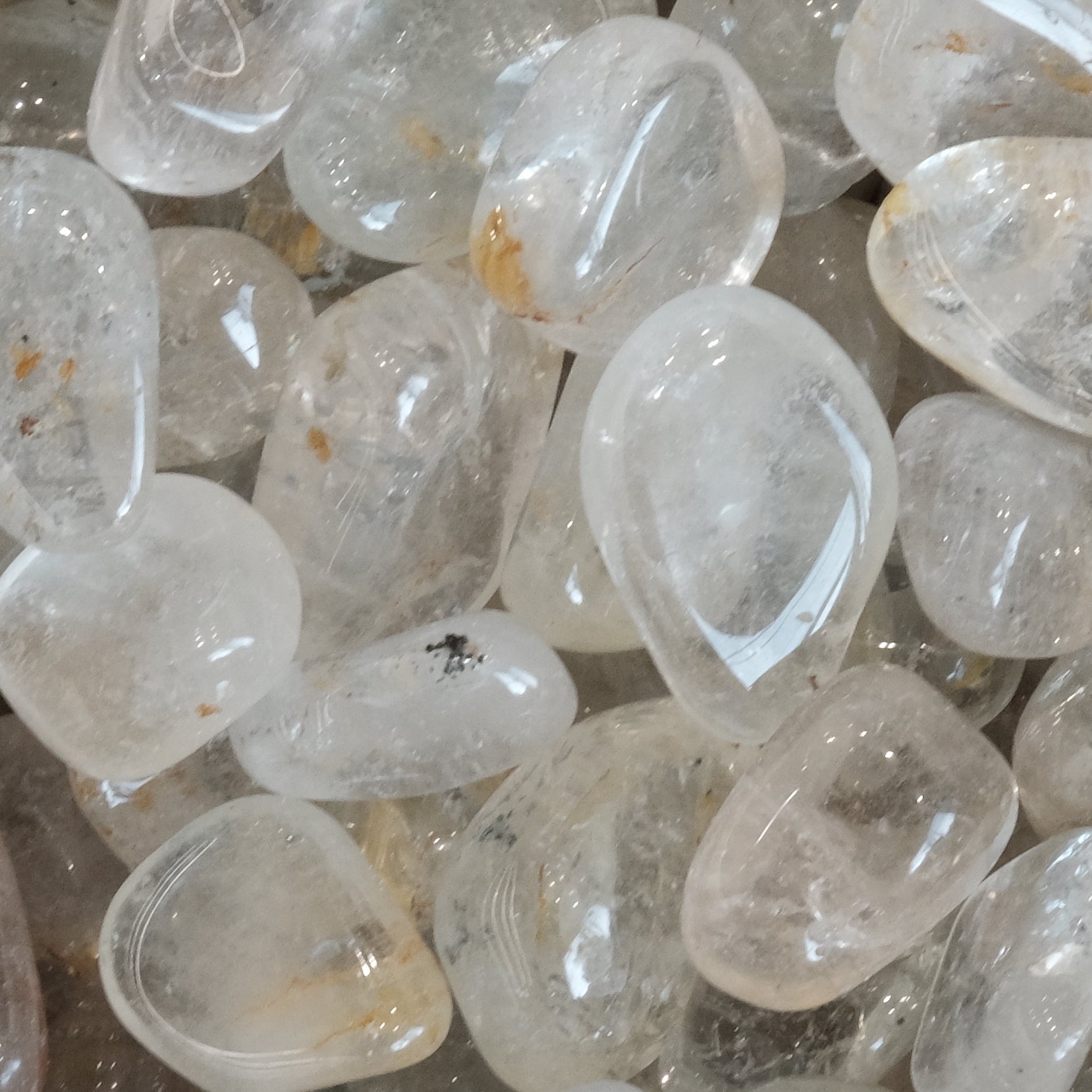 Natural silver topaz tumbled stones for healing, relaxation, and promoting love and good fortune.