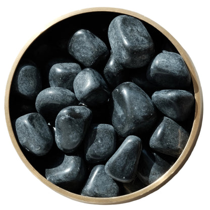 Bowl of black tourmaline tumbled stones used for negative energy protection and grounding.