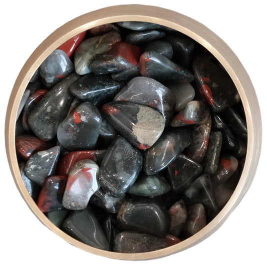 Bloodstone tumbled stones 10-20MM in a circular wooden bowl, known for enhancing vitality and decision-making.