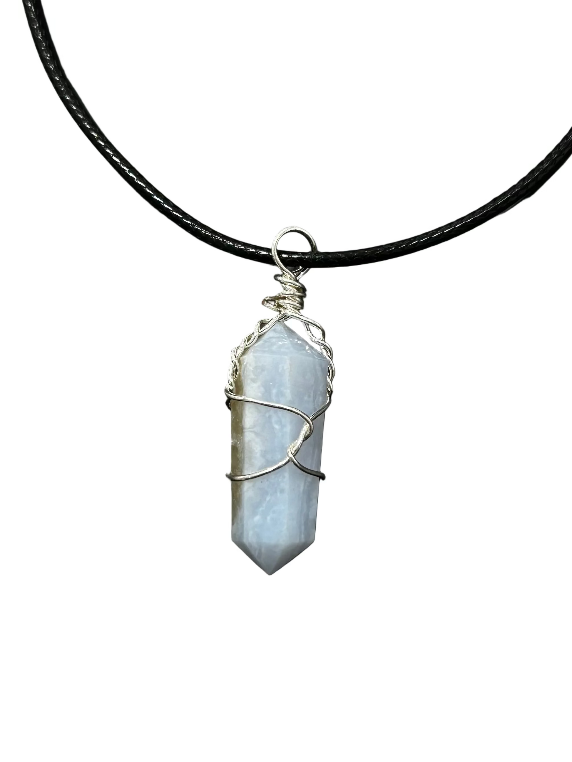 A raw blue lace agate crystal pendant necklace wrapped in silver wire, suspended on a black cord against a dark gray background.