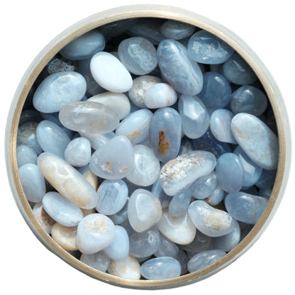 Blue Lace Agate tumbled stones in a wooden bowl, calming and healing crystals for self-assurance and throat health.