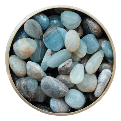 Bowl of polished blue onyx stones promoting strength and calming energy.