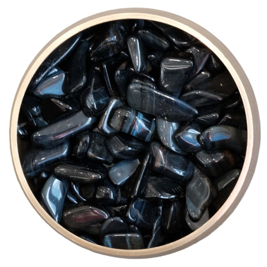 Blue Tiger Eye Hawk's Eye tumbled stones with blue, grey, and black hues in a round container, enhancing perception and calmness.