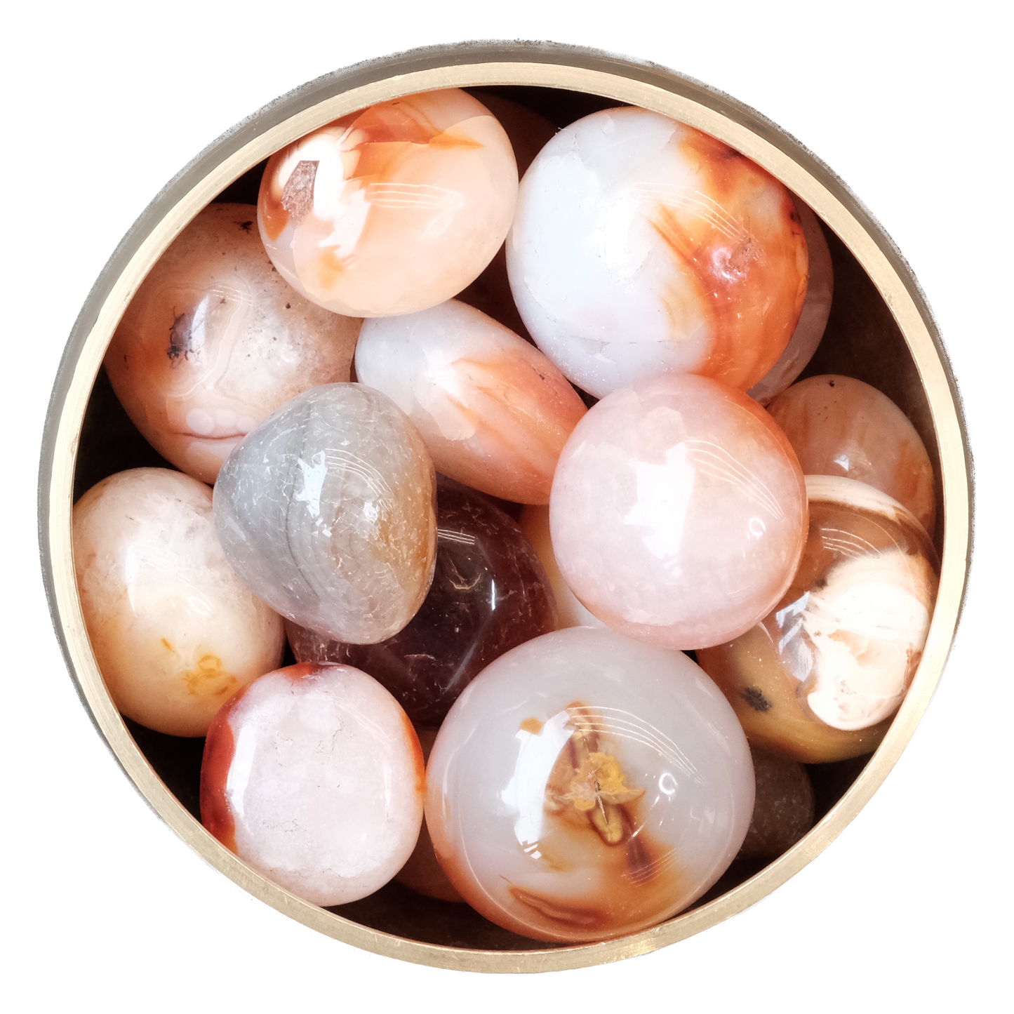 Assorted polished Carnelian stones in a round container showcasing their vibrant orange and red hues.