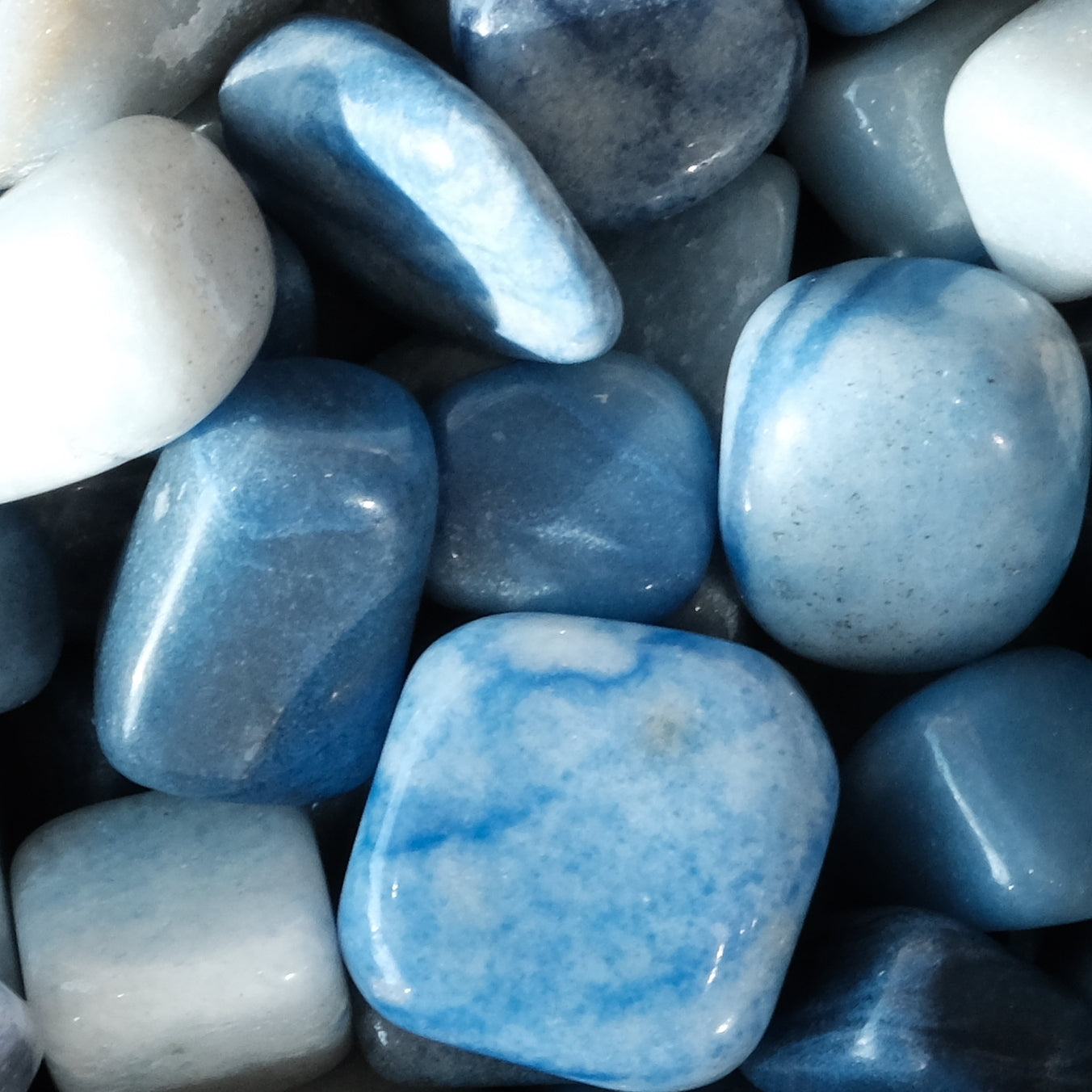 Dumortierite tumbled stones in a calming blue hue, ideal for promoting self-confidence and inner strength.