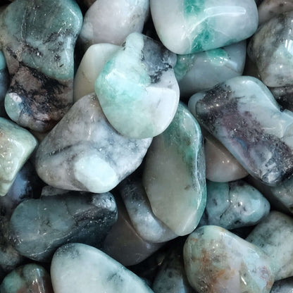 Polished emerald tumble stones 10-20 mm, green and white hues, known for promoting love and harmony, ideal for emotional healing.