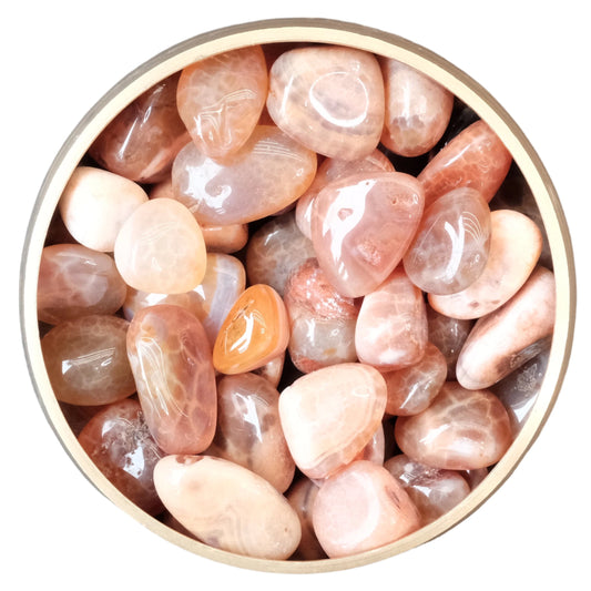 Bowl of tumbled fire agate stones for balance, inner peace, and healing, promoting focus, cognitive abilities, and stress relief.