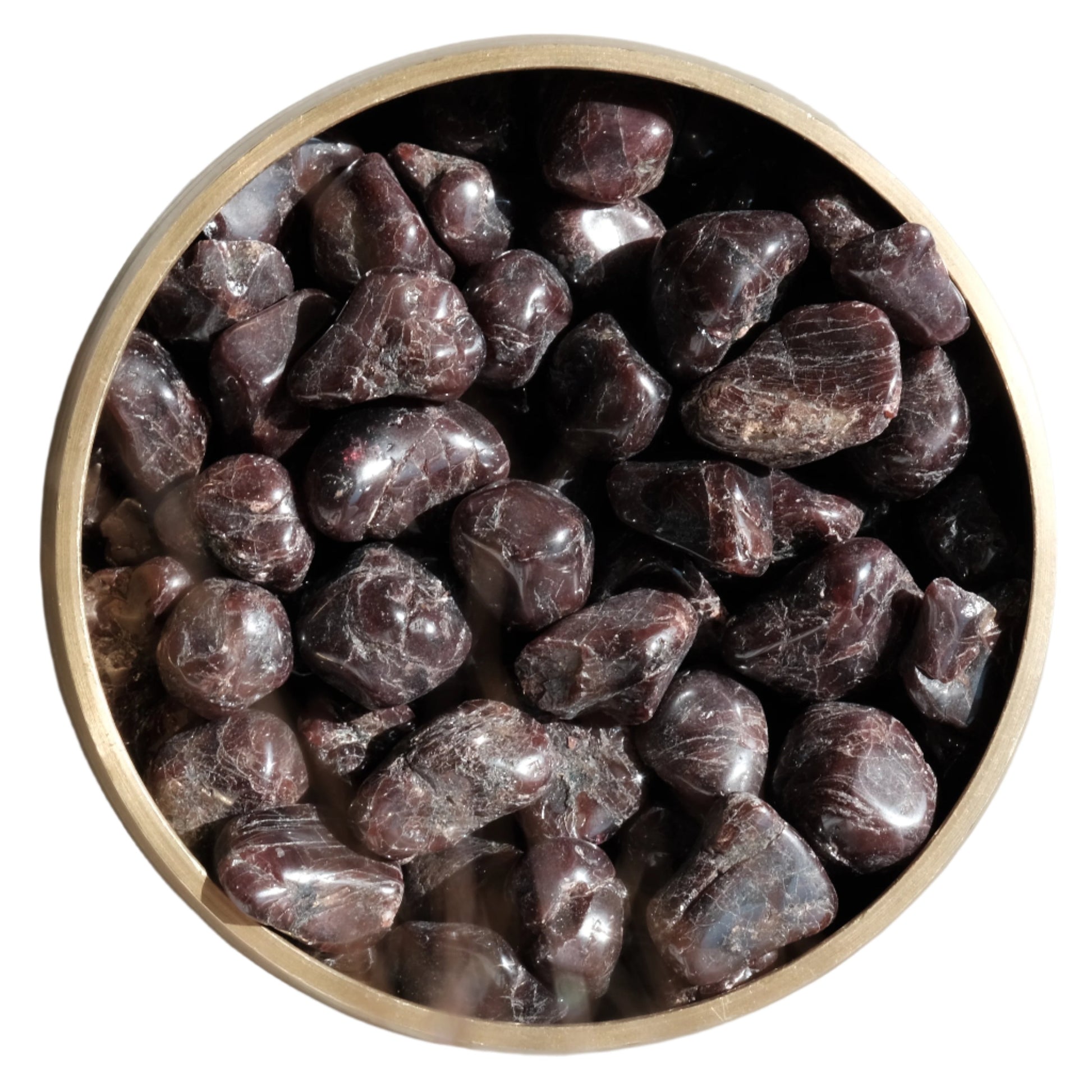 Tumbled garnet stones 10-20mm in a bowl, known for balancing energy and inspiring love and dedication.