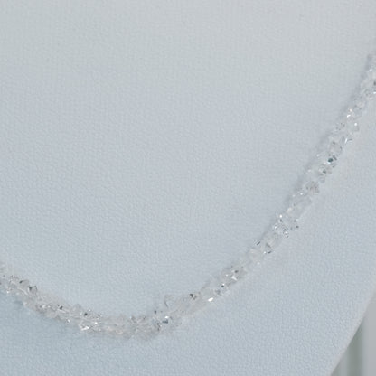 Elegant Herkimer Diamond bead necklace on display against a neutral background.