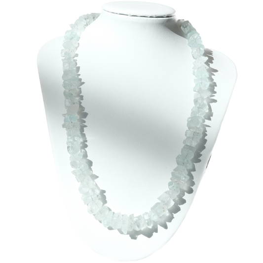 Aquamarine chip necklace on a white display bust, showcasing soothing light blue stones that promote calmness and reduce stress.