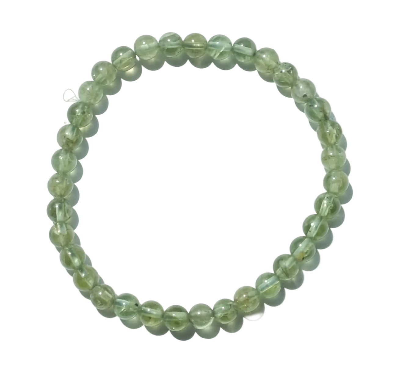 A beaded stretch bracelet made of translucent light green gemstone beads, arranged in a circle on a plain white background.