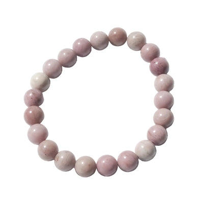 A beaded stretch bracelet made of smooth, polished round beads in shades of dusty pink, mauve, and light cream, arranged in a circle on a white background.