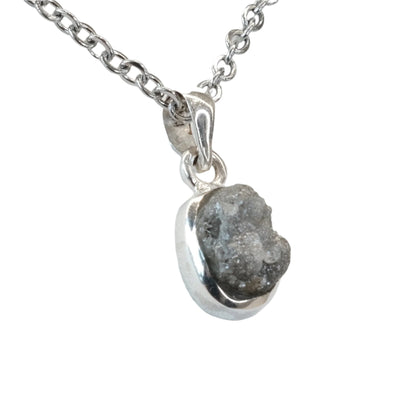 Rough diamond pendant necklace on silver chain showcasing raw beauty and healing properties for clarity and empowerment.