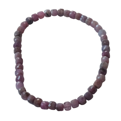 A beaded stretch bracelet made of faceted, round pinkish-purple beads, arranged in a circle on a plain light gray background.