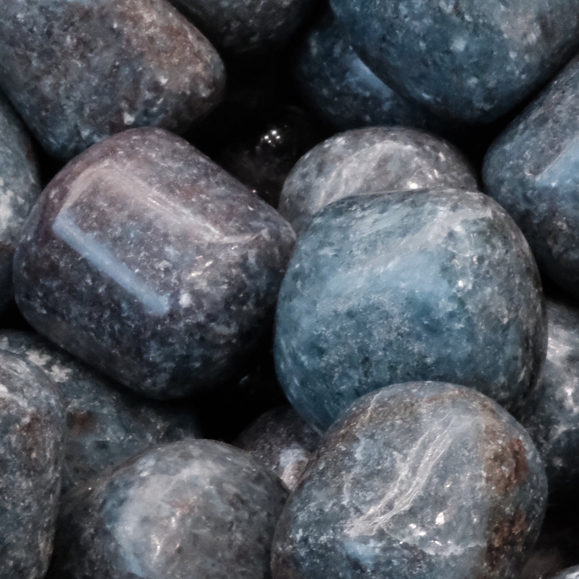 Ruby Kyanite tumbled stones showcasing vibrant blues and reds, blending energies for prosperity, confidence, and love.