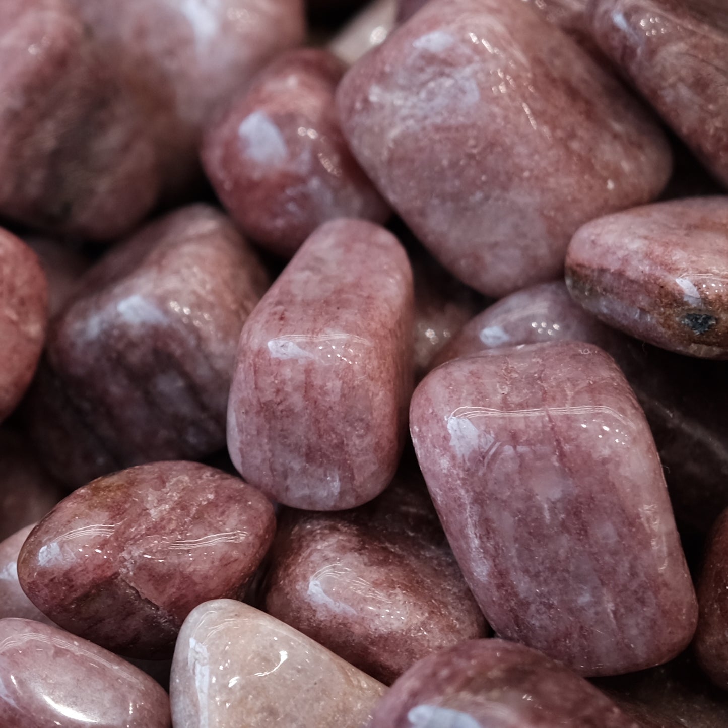 Strawberry quartz tumbled stones 10-20mm, showcasing pink hues with unique red and black mineral inclusions for healing and balance.