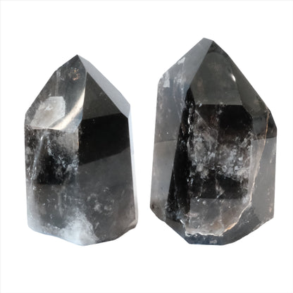 Two smoky quartz towers for grounding and neutralizing negative energy, promoting emotional peace and well-being.