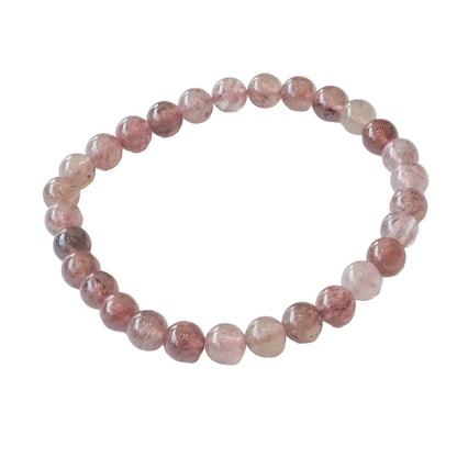 A beaded stretch bracelet made of polished round pinkish-tan beads with natural inclusions, displayed on a clean white background.