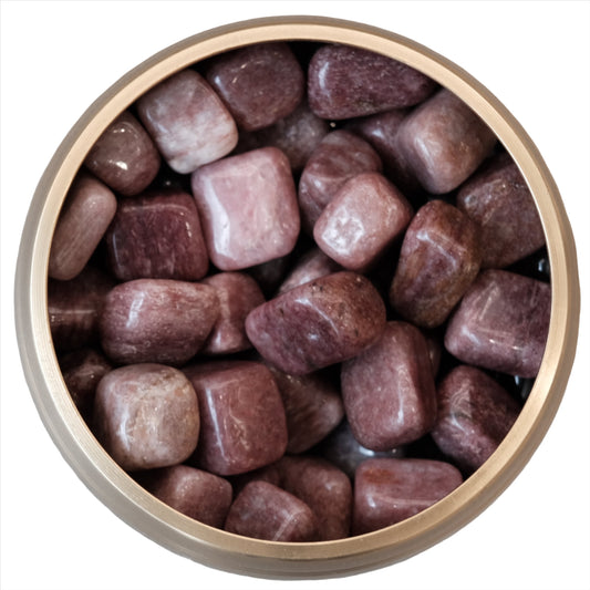 Pink strawberry quartz tumbled stones in a bowl, known for their healing properties and emotional balance benefits.