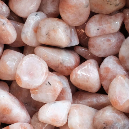 Tumbled sunstone gemstones, 10-20mm, promoting good fortune, energy, and intuition with a glossy, natural appearance.