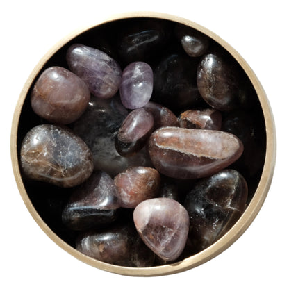 Super 7 tumbled stones in a wooden bowl, showcasing healing crystals that balance and energize the mind, body, and spirit.