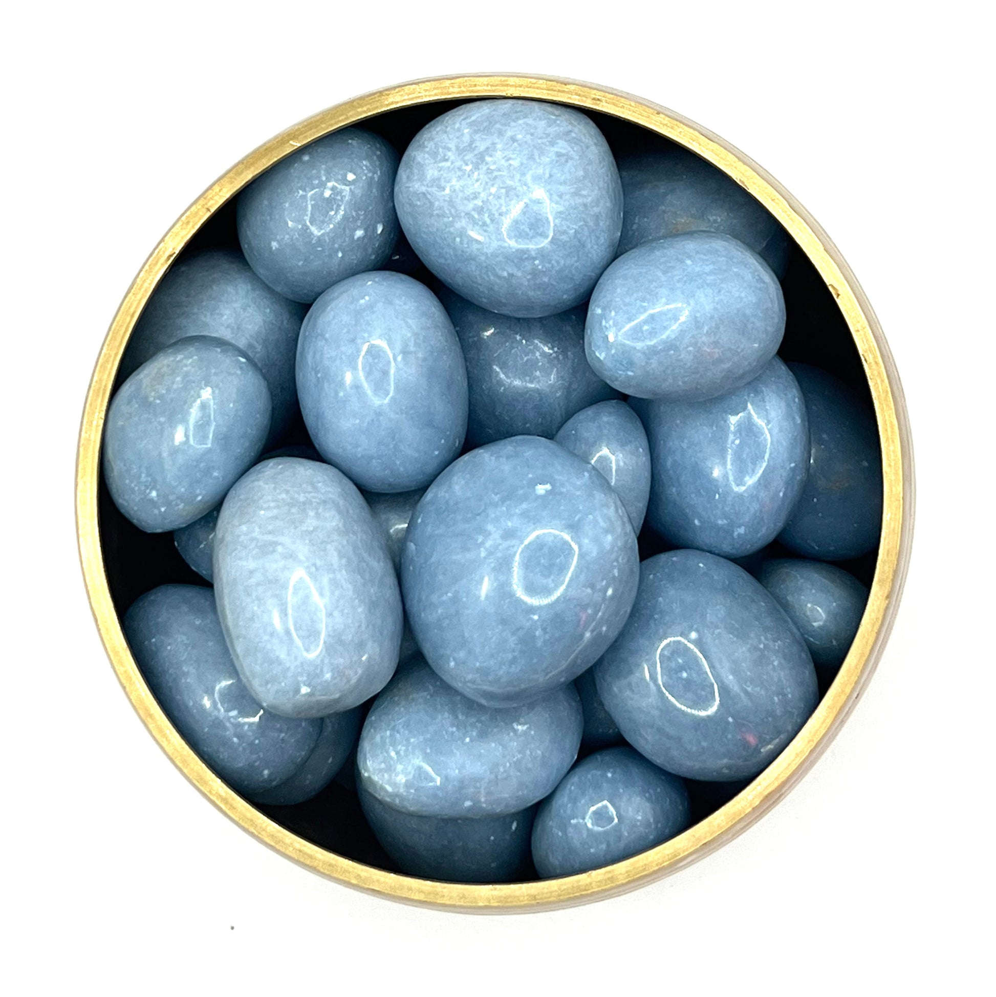Angelite tumbled stones in a round container, displaying calming blue hues and promoting peace, tranquility, and spiritual awareness.